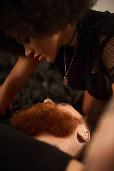 African american woman with curly hair seducing her redhead boyfriend with beard — Stock Photo