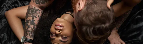 Passionate moment of multicultural couple making love in bedroom, man kissing african american woman — Stock Photo