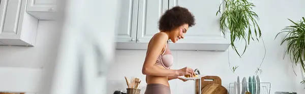 African american woman in lingerie with pink patches under eyes washing plate with sponge, banner — Stock Photo