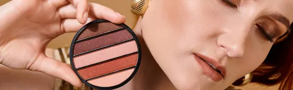 Banner of cropped woman holding eye shadow palette near face on beige background, makeup concept — Stock Photo