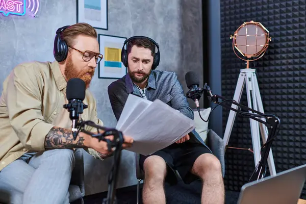 Hard working red haired interviewer discussing main questions with his young guest during podcast — Stock Photo