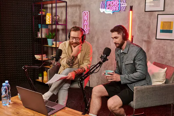 Good looking interviewer in casual attire discussing questions with his young guest during podcast — Stock Photo