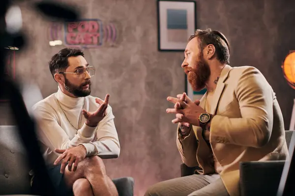 Two handsome bearded men in elegant stylish attires sitting and discussing interview questions — Stock Photo