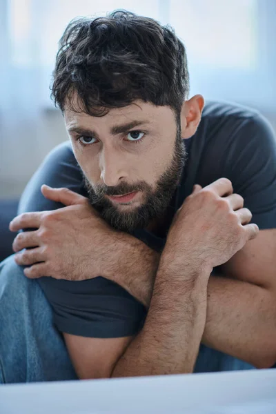 Anxious man in everyday t shirt suffering during depressive episode, mental health awareness — Stock Photo