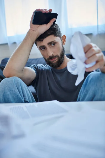 Bearded suffering man in casual attire looking at contract and pills during breakdown, mental health — Stock Photo