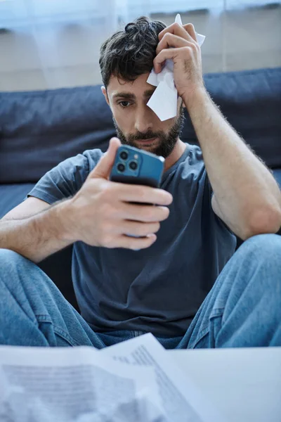 Homem sofredor deprimido olhando para seu smartphone durante episódio depressivo, saúde mental — Fotografia de Stock