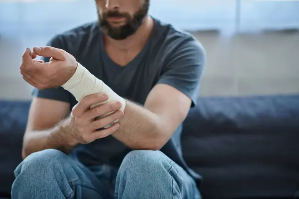 Cropped view of depressed man with bandage on arm after attempting suicide, mental health awareness — Stock Photo