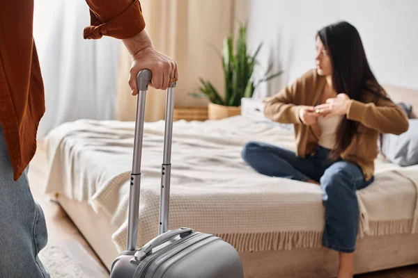 Depressed asian woman taking off wedding near husband with suitcase leaving home, family divorce — Stock Photo