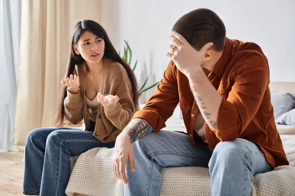 Frustrated asian woman talking  at young asian husband talking with tattooed husband — Stock Photo