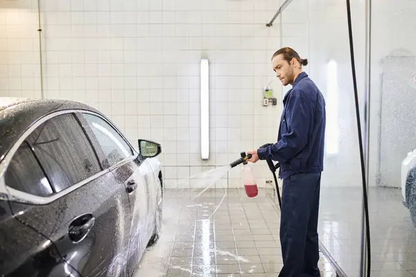 Attractive dedicated specialist in blue uniform with collected hair using soap to wash car — Stock Photo