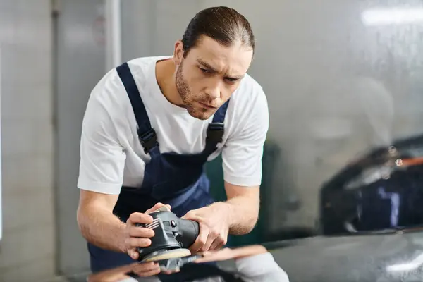 Attractive devoted serviceman in uniform with collected hair using polishing machine carefully — Stock Photo