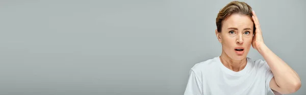 Appealing surprised blonde woman with collected hair and contact lenses looking at camera, banner — Stock Photo