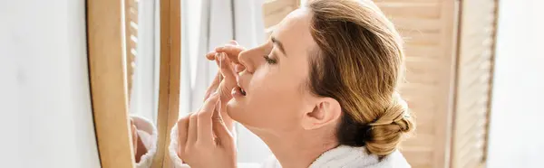 Beautiful blonde woman with collected hair in bathrobe cleaning her teeth with dental floss, banner — Stock Photo