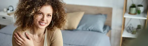 Curly young woman smiling woman looking at away happily, morning couple time at bedroom, banner — Stock Photo