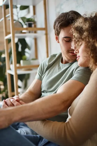 Curly young woman and brunette man hugging lovingly, feeling grateful for the moment — Stock Photo