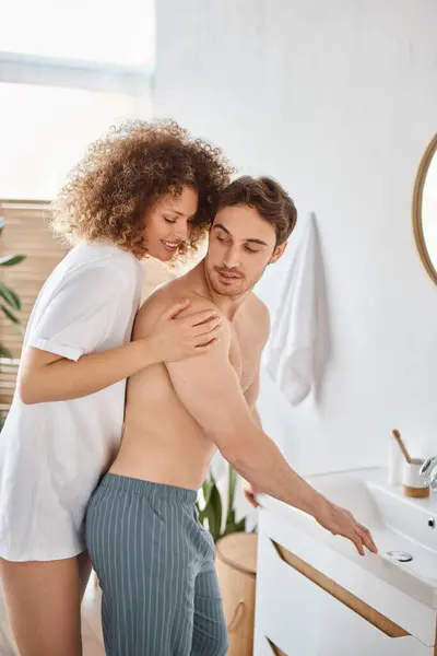 Young couple in love hugging and smiling at each other at home in the bathroom, tender morning — Stock Photo
