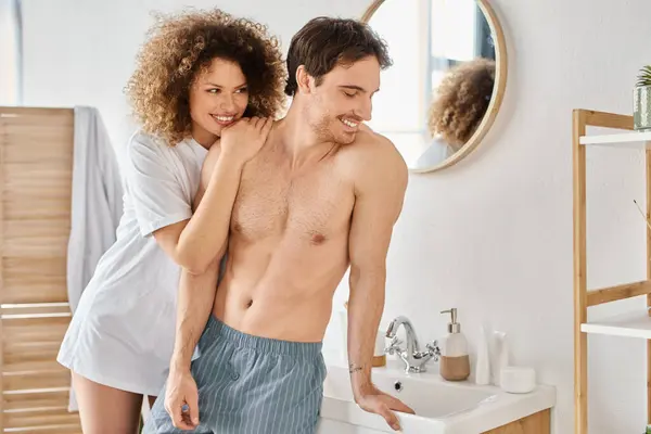Portrait of happy young couple cuddling in the bathroom hugging in love and smiling — Stock Photo