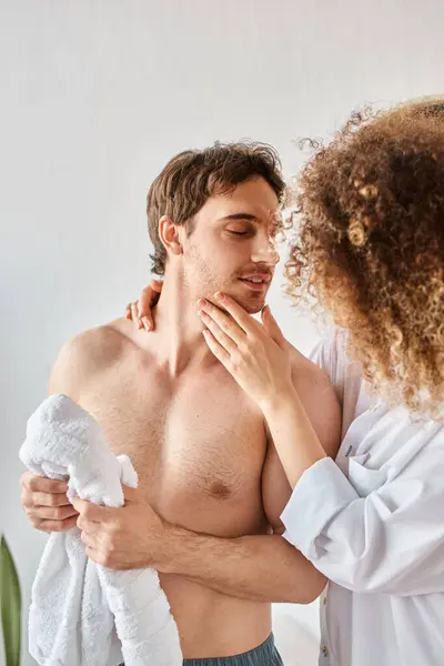 Morning couple in love in bathroom. Young curly woman touching her boyfriend's cheek in bathroom — Stock Photo