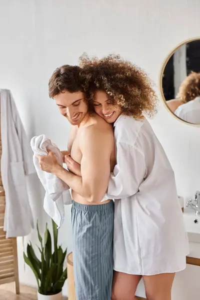 Morning couple in love in bathroom. Young curly woman hugging her boyfriend's from behind — Stock Photo