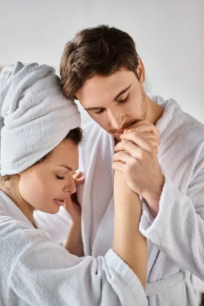 Morning couple in love in bathroom. Handsome man kissing girlfriend hand gently - foto de stock
