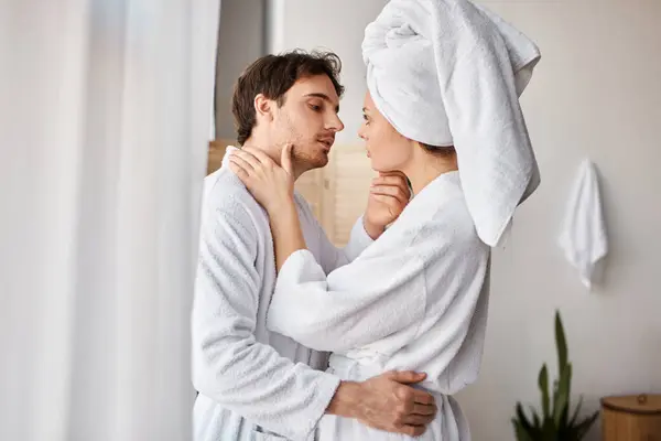 Attractive couple in love in bathroom hugging and cuddling, man touching his girlfriend waist - foto de stock