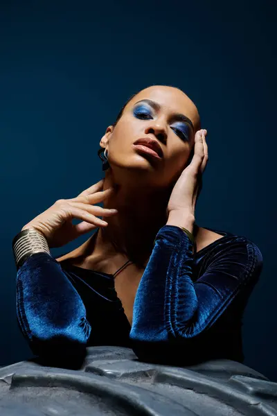 A young African American woman confidently showcasing her striking blue makeup. — Stock Photo