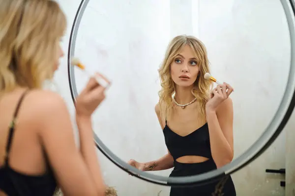 Applying makeup in mirror reflection — Stock Photo