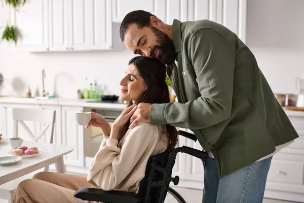 Cheerful loving man spending time at breakfast with his disabled beautiful wife in wheelchair — Stock Photo