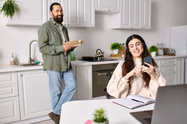 Positive disabled woman in wheelchair working remotely at home next to her reading husband — Stock Photo
