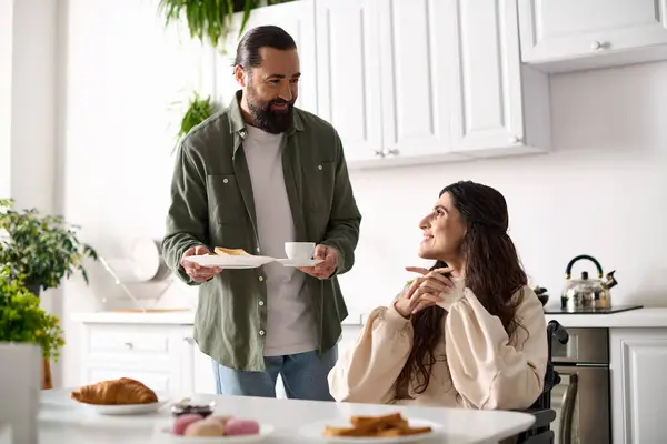Bearded loving man bringing his cheerful wife with disability toasts and hot coffee at breakfast — Stock Photo