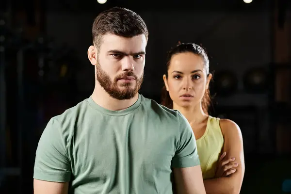 Male trainer demonstrates self-defense techniques to a woman in a gym. — Stock Photo