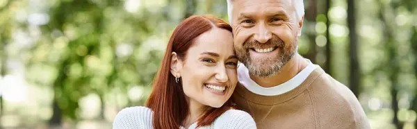 A loving couple in casual attire posing for a picture in a park. — Stock Photo