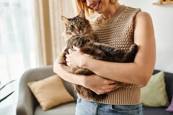 A captivating woman with short hair peacefully holding a cat in her arms. — Stock Photo
