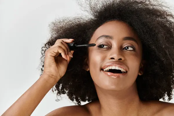 A beautiful young African American woman with curly hair, embodying a beauty concept in a studio setting. — Stock Photo
