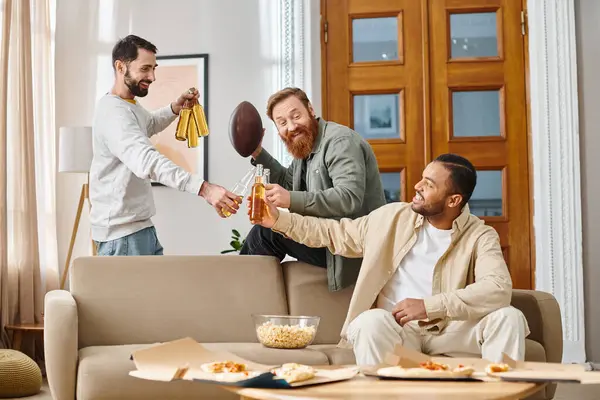 Three diverse, joyful men in casual clothing sit on a couch, radiating friendship and unity as they enjoy each others company. — Stock Photo