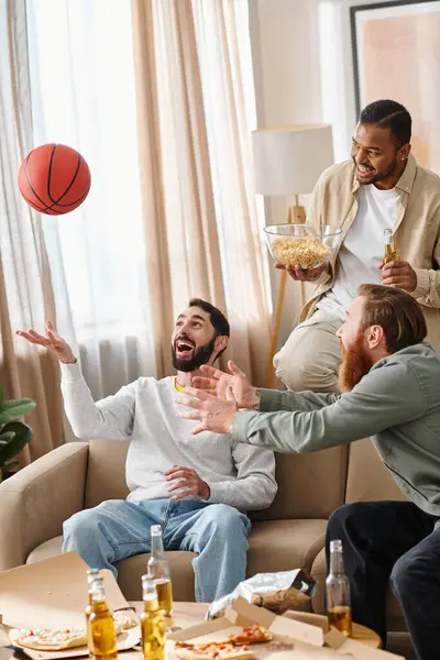 Three cheerful, interracial men in casual attire play a competitive game of basketball, showcasing friendship and teamwork. — Stock Photo