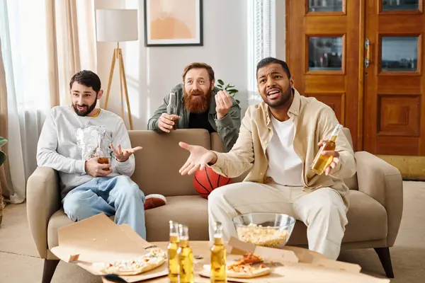 Three handsome, cheerful men of different races in casual attire bond and relax on a couch, embodying the essence of friendship. — Stock Photo