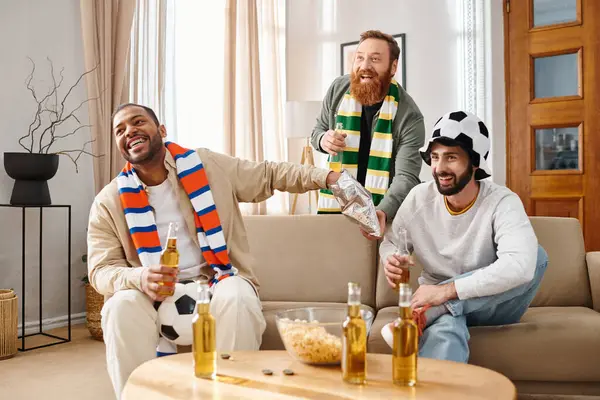 Three stylish men, different ethnicities, sit happily on a sofa, building a heartwarming friendship. — Stock Photo
