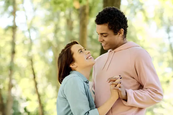 A loving couple, diverse and vibrant, stand side by side in the peaceful embrace of the woods. — Stock Photo