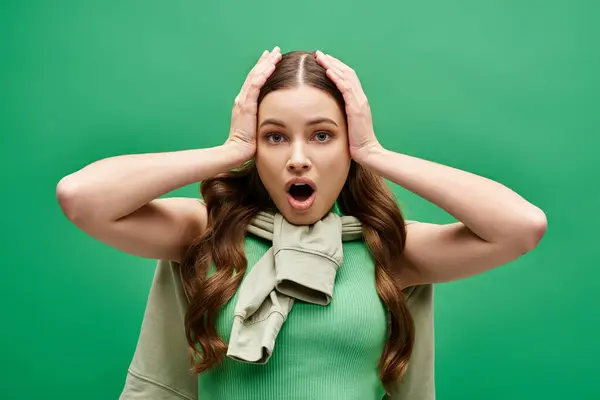 A shocked young woman in her 20s covering her ears with her hands. — Stock Photo