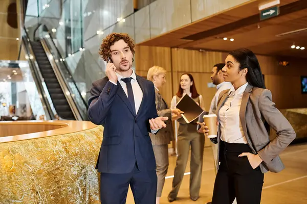 A multicultural businessman in a sharp suit conversing on a cellphone. — Stock Photo