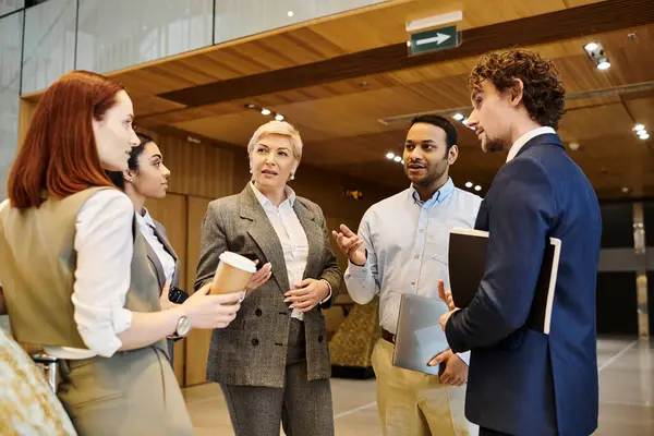 A group of people of different races and backgrounds engaged in a discussion. — Stock Photo