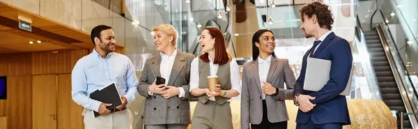 A diverse group of business professionals stand in a circle, discussing work strategies. — Stock Photo