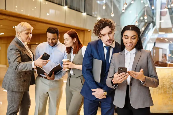 Diverse business team engrossed in smartphones. — Stock Photo