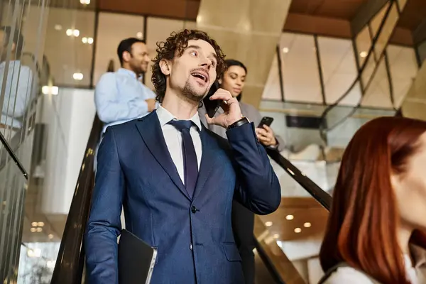 A man in a suit of a different ethnicity talking on a cell phone. — Stock Photo
