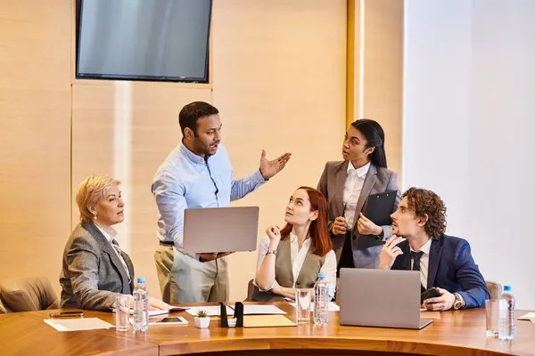 Multicultural business professionals brainstorm around a conference table. — Stock Photo