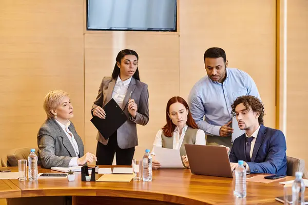 Business professionals of different backgrounds collaborate at conference table. — Stock Photo