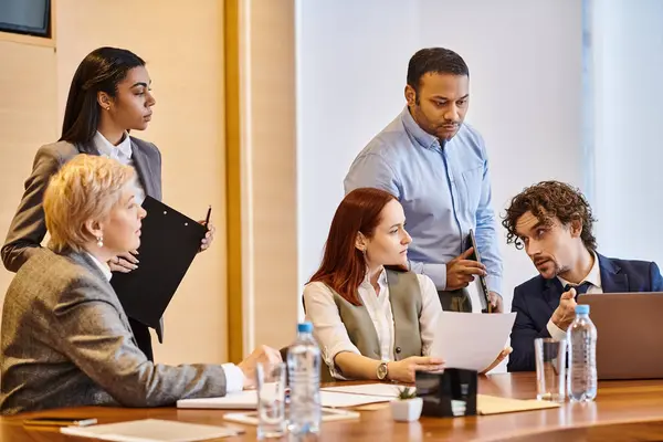 Diverse group of business professionals collaborating at conference table. — Stock Photo