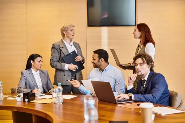 An interracial group of business professionals discussing strategy at a conference table. — Stock Photo