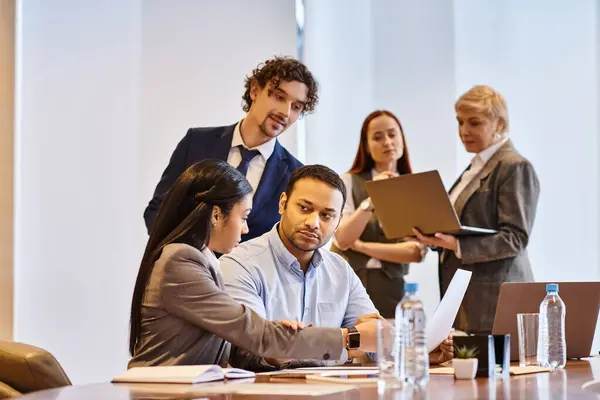 Multicultural business team collaborating around conference table. — Stock Photo